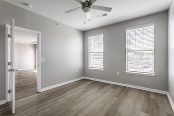 the living room of an empty house with a ceiling fan at Alexandria of Carmel Apartments, Carmel